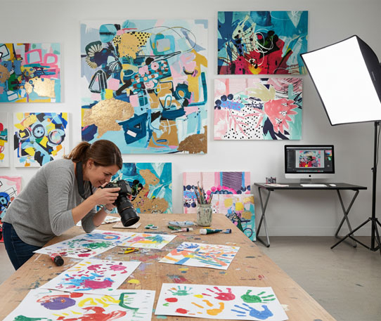 Artist photographing artwork